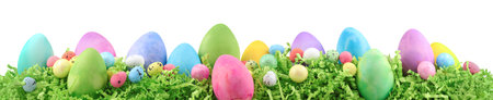 Painted Easter eggs and decorations on arranged on Easter grass.