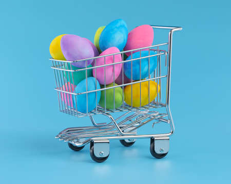 Colorful Easter eggs piled in shopping cart for Easter shopping.の写真素材
