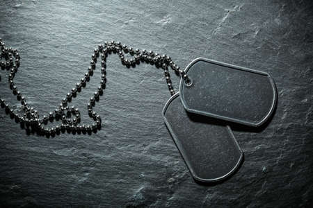 American military dog tags. Rough and worn with blank space for text. Memorial Day or Veterans Day concept.の写真素材
