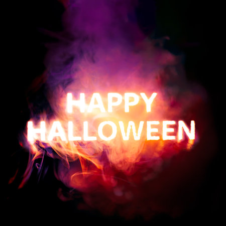 Glowing Happy Halloween text burning red, orange, and purple smokeの写真素材