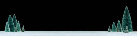 Peaceful winter scene with miniature snow covered trees on glittering snow.の写真素材