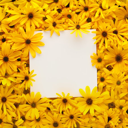 Wall of bright yellow flowers with square blank white card for copy space.