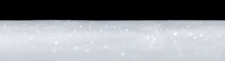 Banner of smooth sparkling glittering white snow isolated on blackの写真素材