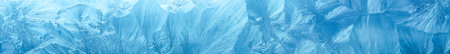 Wintry background with winter frost covered window with a pattern of ice crystals.の写真素材