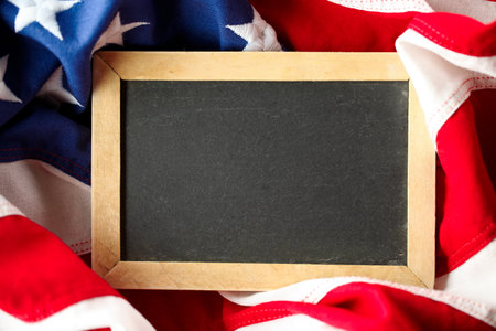 US American flag surrounding empty chalkboard with blank space for text or advertisingの写真素材