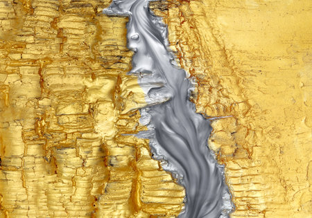 Textured shiny gold with silver paint swirling.の写真素材