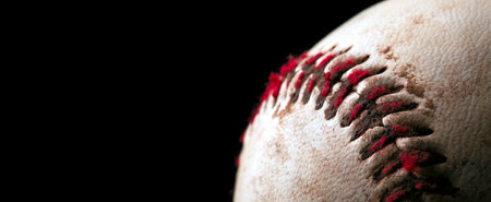 Close up of old worn baseball showing dirty red stitches. Blank space for text.の写真素材