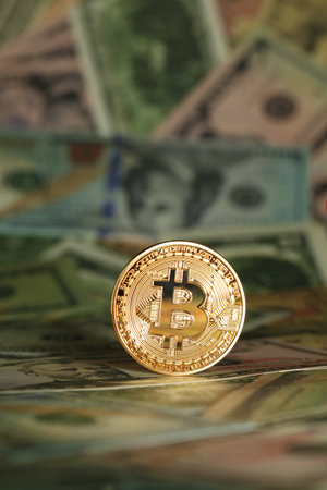 Shiny bright golden bitcoin, balanced on piles of money. Wealth, digital, virtual, currency, and cryptocurrency concept.の写真素材