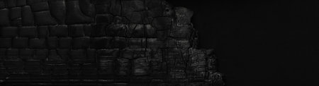 Cracked and scratched surface of a burned and charred wooden plank, burnt to ashes.の写真素材
