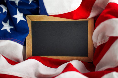 US American flag surrounding empty chalkboard with blank space for text or advertisingの写真素材