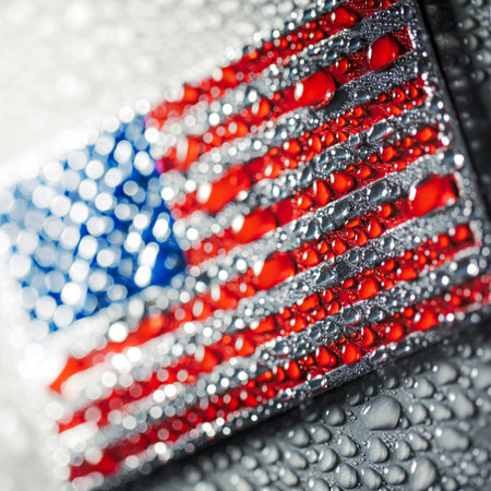 Shiny metal US American flag covered in water drops. Patriotic USA flag symbolizing the United States of America for 4th of July, Memorial day, Labor day, or other USA celebration.の写真素材