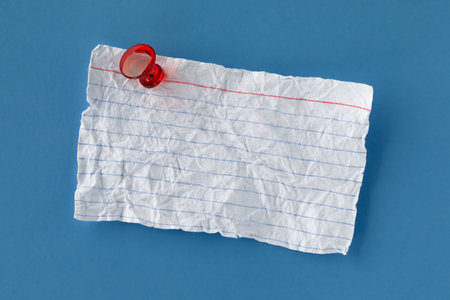Worn and faded index card pinned with red tack. Blank copy space for notice, message, or reminder.の写真素材