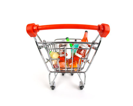 Fisheye view of shopping basket or grocery cart full of groceries and shopping. Isolated on white.の写真素材