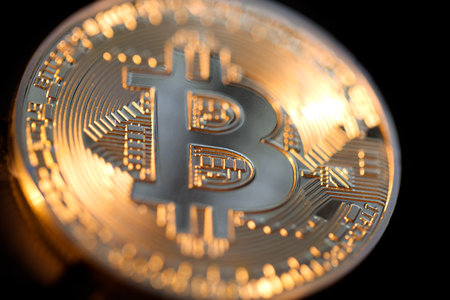 Close up of a single shiny bitcoin coin.  Wealth, digital, virtual, currency, and cryptocurrency concept.の写真素材