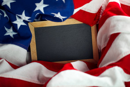 US American flag surrounding empty chalkboard with blank space for text or advertisingの写真素材