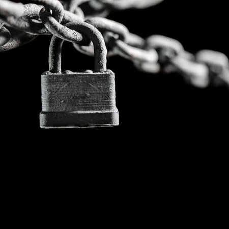 Worn rusted chain and pad lock on black background. Conceptual strength, protection, or security system.の写真素材
