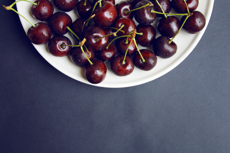 Red cherries on black backgroundの写真素材