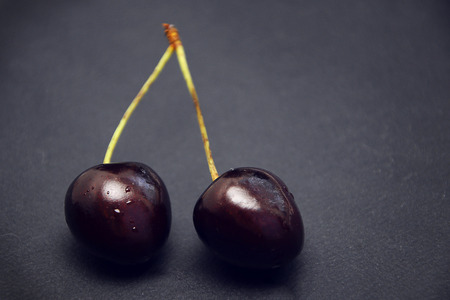 Red cherries on black backgroundの写真素材