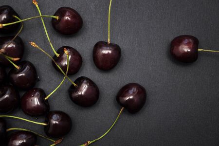 Red cherries on black backgroundの写真素材