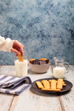 Delicious biscuits with milk glass on a table topの写真素材
