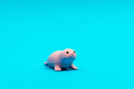 Small animal figure toy for children on a blue background isolatedの写真素材