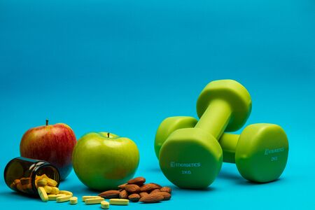 Fitness weights, apples and vitamins to exercise and stay healthy and fitの写真素材
