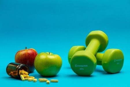 Fitness weights, apples and vitamins to exercise and stay healthy and fitの写真素材
