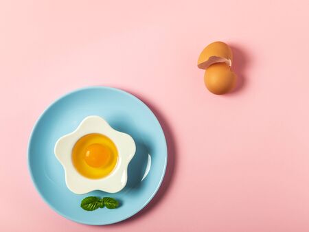 Raw eggs on a solid pink color backgroundの写真素材