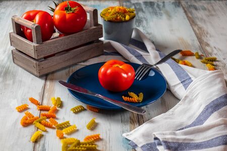 Ripe and fresh tomatoes from farmer's market, salt, pepper and basil with tomato juice and pastaの写真素材