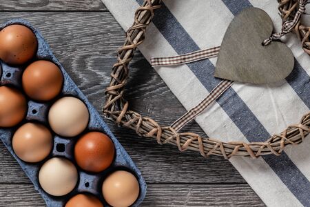 Fresh farmer market eggs on a kitchen table with utensilsの写真素材