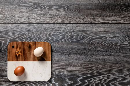 Fresh farmer market eggs on a kitchen table with utensilsの写真素材