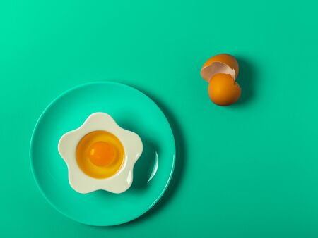 Raw eggs on a solid green color backgroundの写真素材