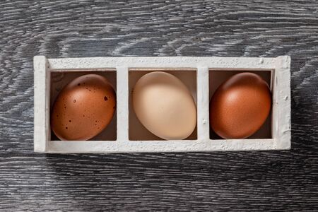Fresh farmer market eggs on a kitchen table with utensilsの写真素材