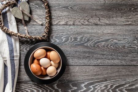 Fresh farmer market eggs on a kitchen table with utensilsの写真素材
