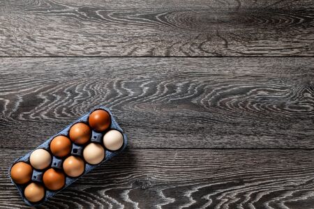 Fresh farmer market eggs on a kitchen table with utensilsの写真素材
