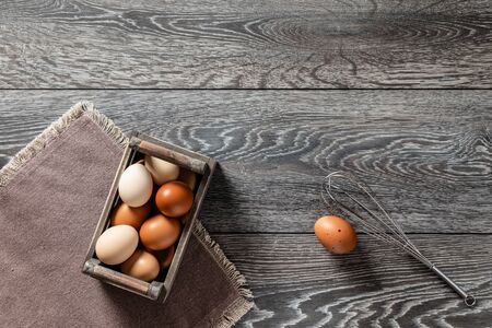 Fresh farmer market eggs on a kitchen table with utensilsの写真素材