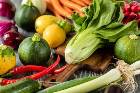 Healthy Organic Vegetables on the Wooden Background. Zucchini, carrots, red hot chili peppers, onionの写真素材