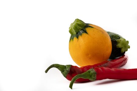 Red hot chili peppers and zucchini isolated on white backgroundの写真素材