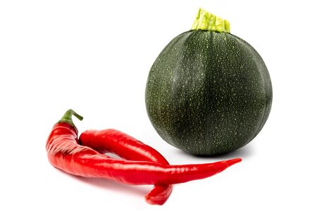 Red hot chili peppers and zucchini isolated on white backgroundの写真素材