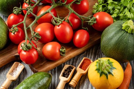 Healthy Organic Vegetables on the Wooden Background. Zucchini, carrots, red hot chili peppers, onionの写真素材