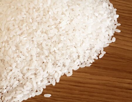 Raw rice on wooden backgroundの写真素材