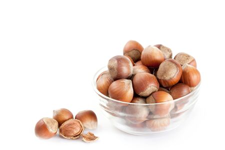 whole hazelnuts in a glass bowlの写真素材