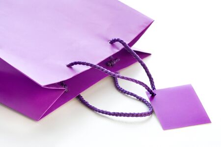 lilac paper bag lying on a white backgroundの写真素材