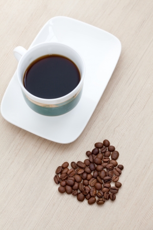 coffee cup with beans in the form of heartの写真素材