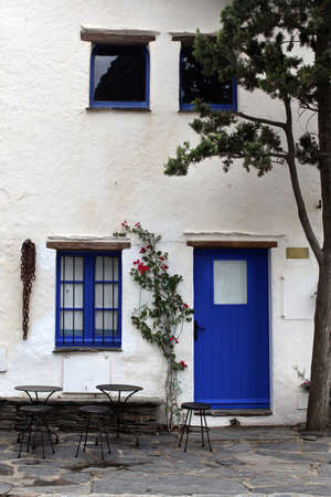 windows and door painted in blue color and Table With Chairs at Italyのeditorial素材