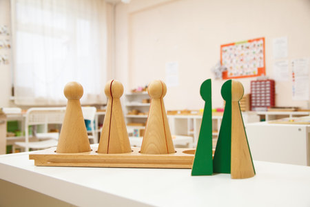 Wooden cones for Studying Fractions against the background of the montessori class.の写真素材