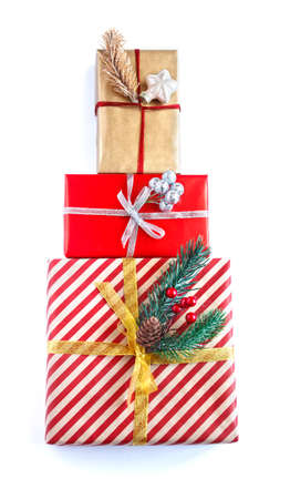 Three decorated christmas boxes striped, red and golden stand on top of each other isolated on whiteの写真素材