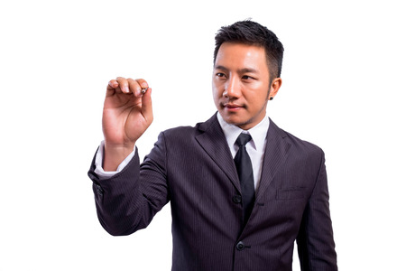 Asian businessman writing on tablet pc touch screen isolate   の写真素材
