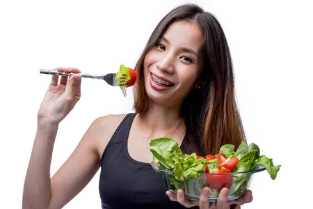 Asia woman Healthy eating a fresh salad,Healthy Lifestyle isolated on white with clipping path.の写真素材