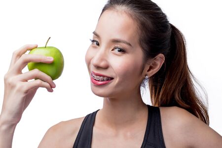 beautiful asian woman holding a green apple isolated on white with clipping path.の写真素材